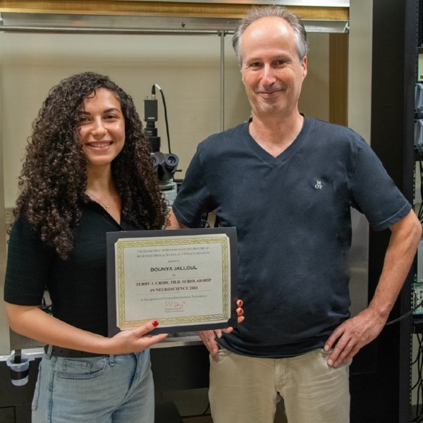 Beierlein standing with Jalloul holding her Terry J. Crow, PhD Scholarship.