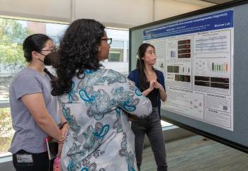 PhD student Heather Tsong with the GSBS Genetics and Epigenetics Program explains her research poster to GSRD attendees as part of the event’s poster session. More than 35 GSBS students participated in the contest.