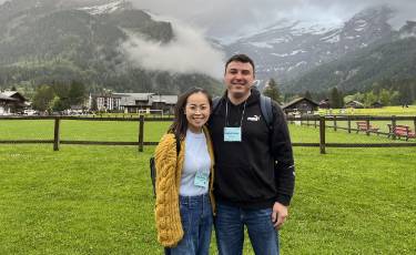 Chuong and Farmer standing in front of mountain in Les Diablerets, Switzerland.