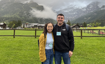 Chuong and Farmer standing in front of mountain in Les Diablerets, Switzerland.