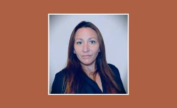woman with dark hair looking at the camera