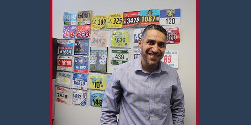 Ahmed Mansour standing with his marathon bibs.