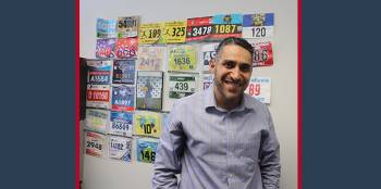 Ahmed Mansour standing with his marathon bibs.