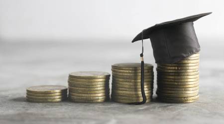  Stacks of coins with a graduation mortarboard on top of one stack 