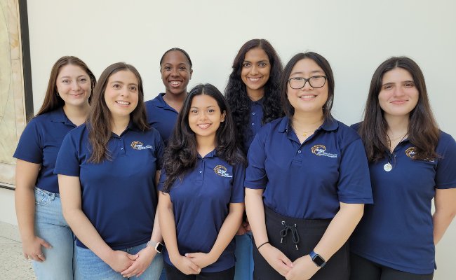 women in dark blue polo shirts