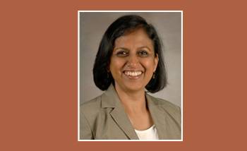 smiling woman on an orange background with a white border