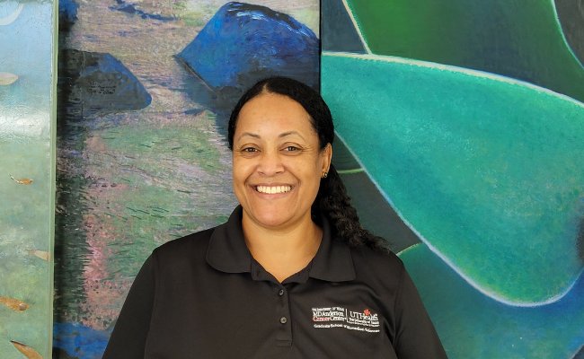 Woman smiling against a blue and green background