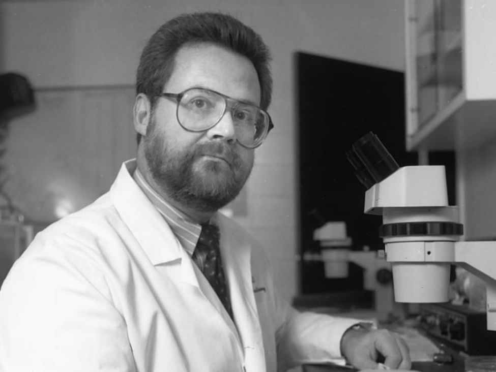 Terry Crow, PhD with microscope