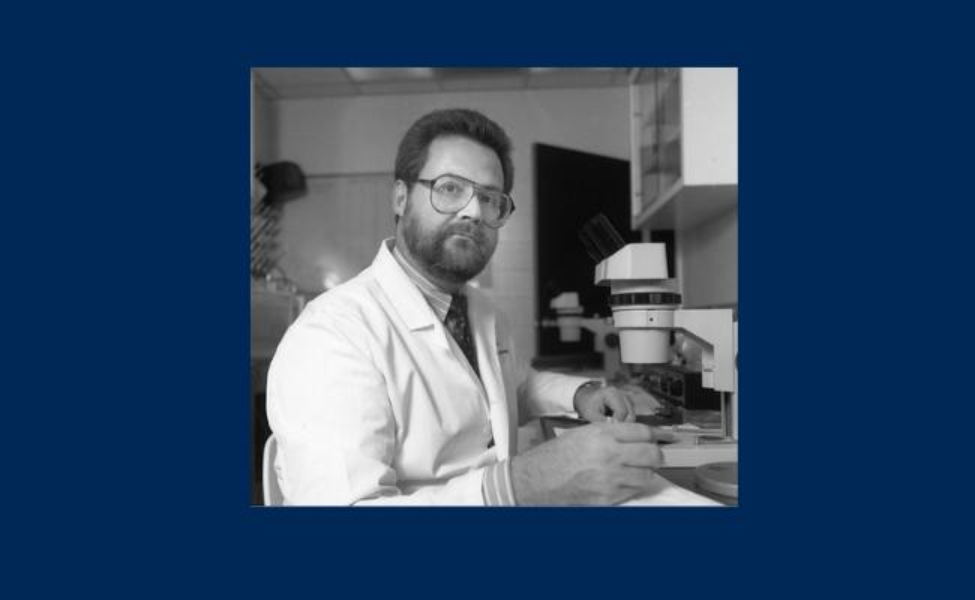 man in glasses and a lab coat working in a lab