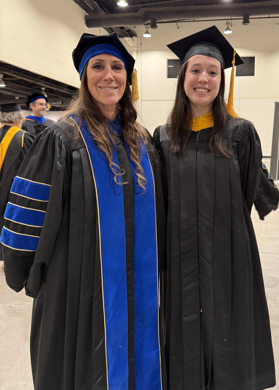 Eckel-Mahan standing with Wienke before the 2026 Commencement ceremony.