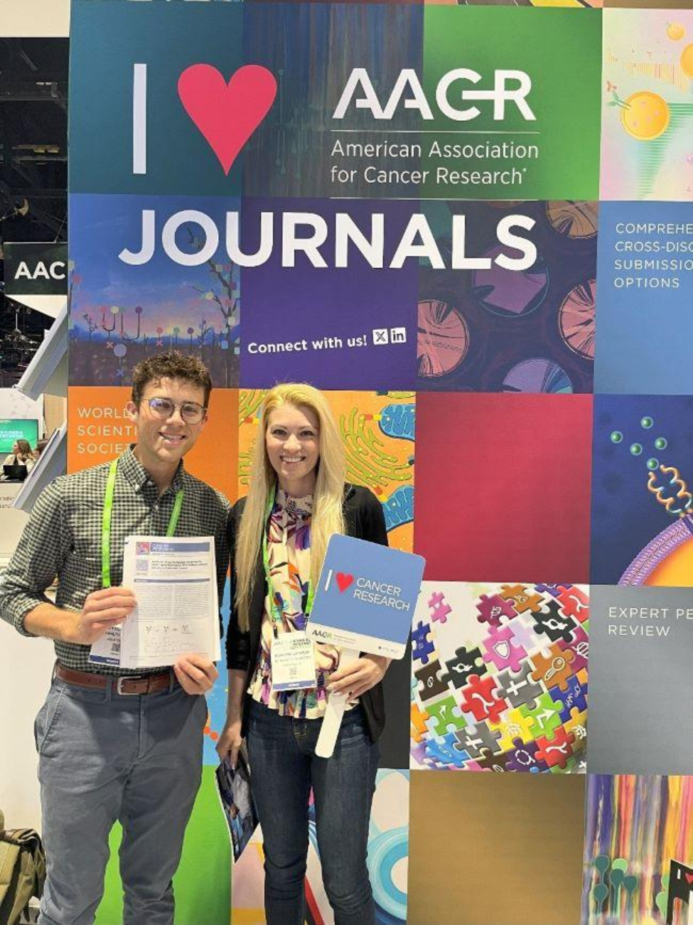 High and his mentor, Kendra Carmon, PhD, standing by sign at the American Association for Cancer Research 2025 Annual Meeting.